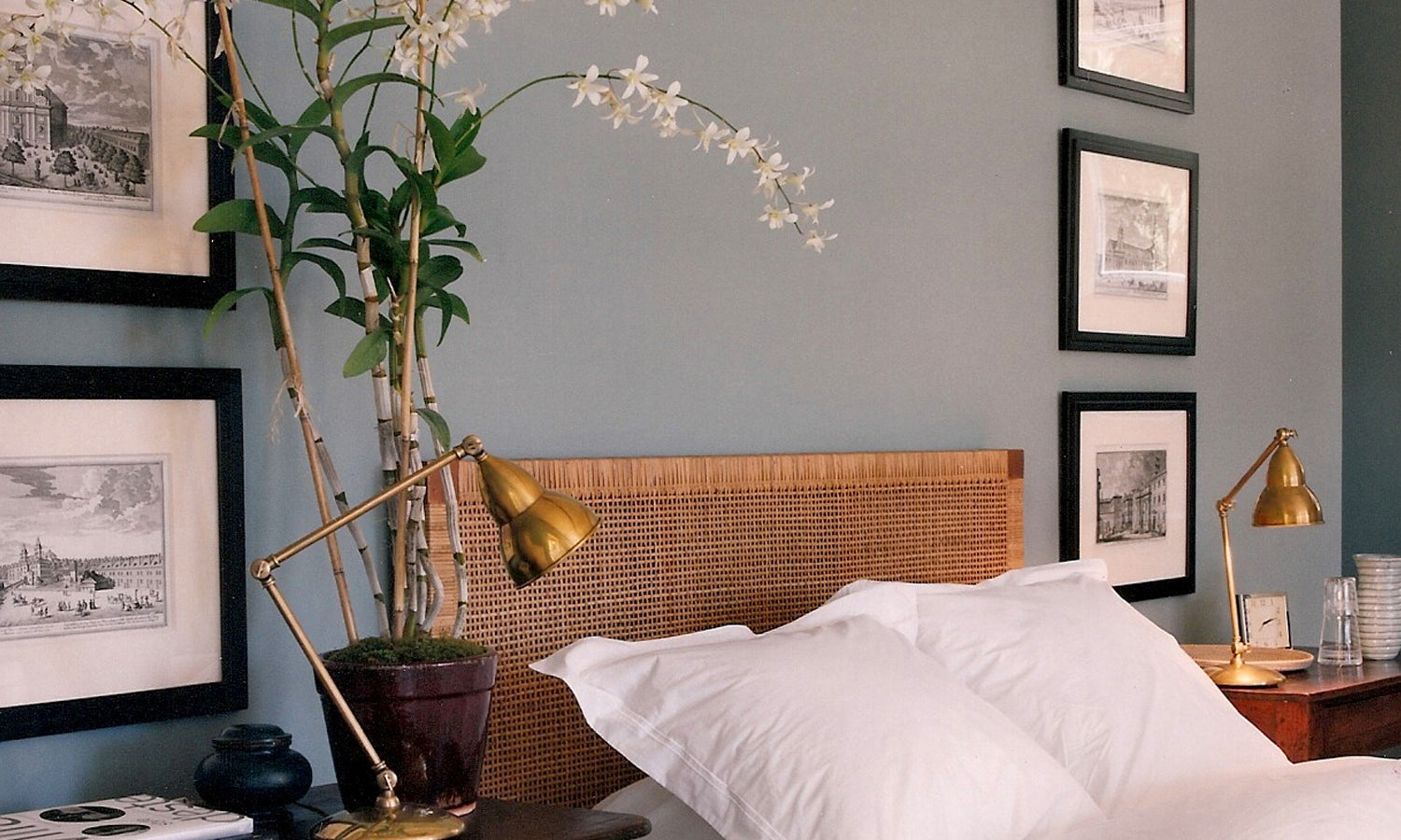 A bed with white sheets and a green plant resting on it, creating a fresh and inviting atmosphere.